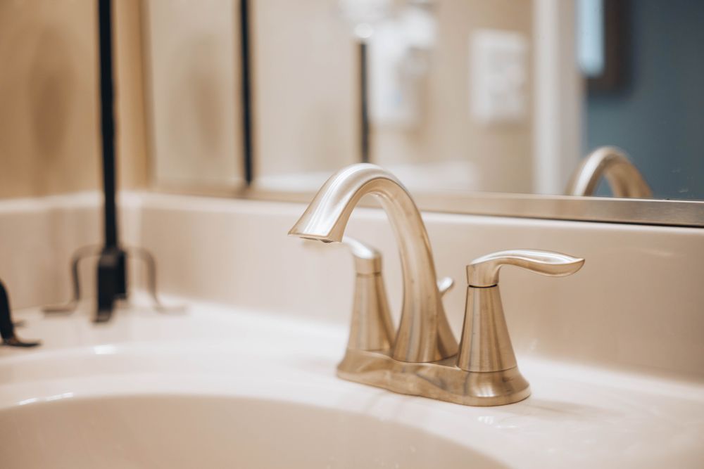 Stainless steel faucet over a white ceramic sink