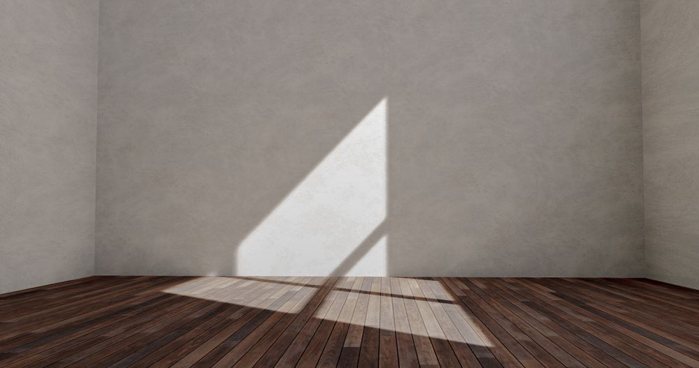 Sunlit empty room with wooden plank flooring