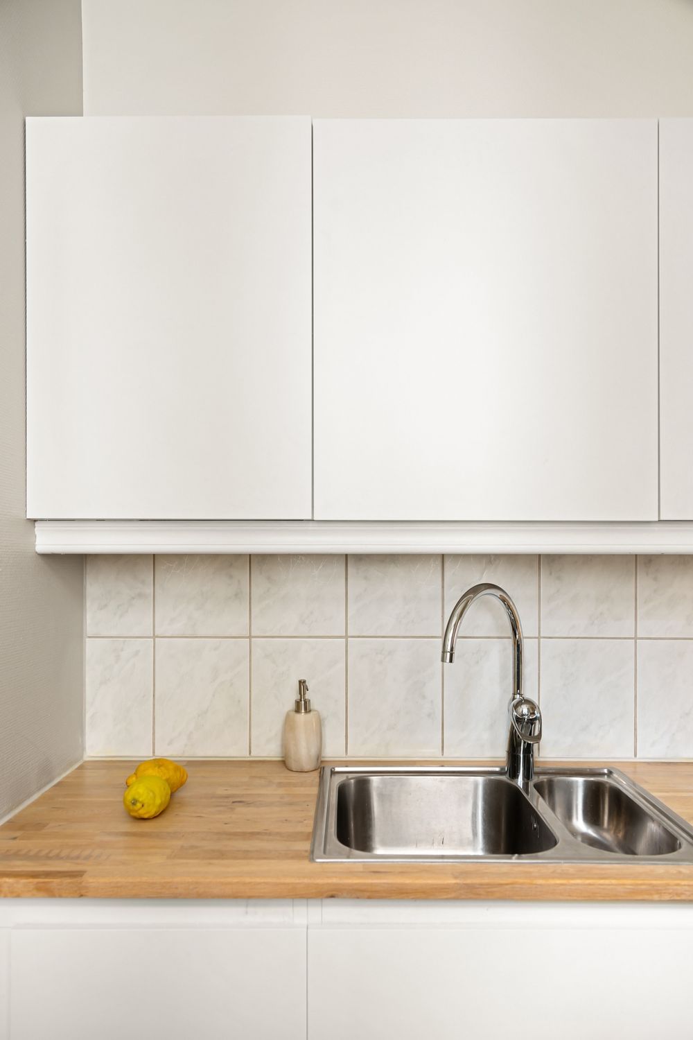 Minimalist kitchen counter with white cabinets and simple styling