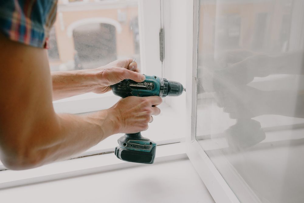 Freeing a window sash with a screwdriver during repair work