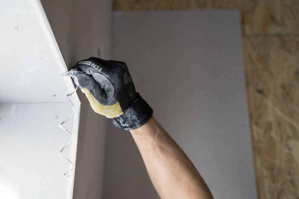 Applying joint compound to a wall with a putty knife