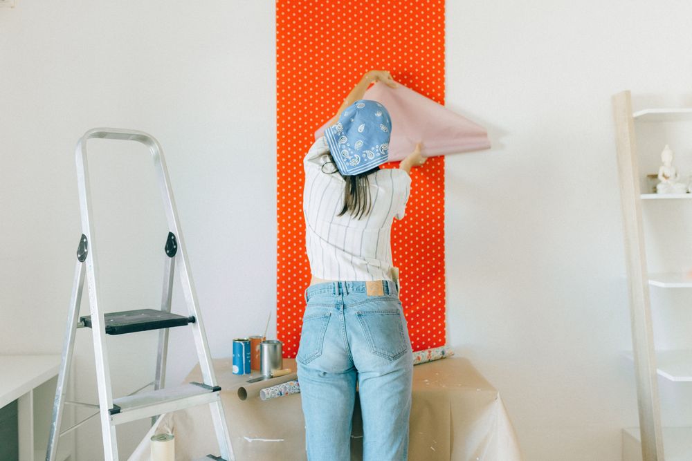 Applying removable wallpaper during an apartment makeover
