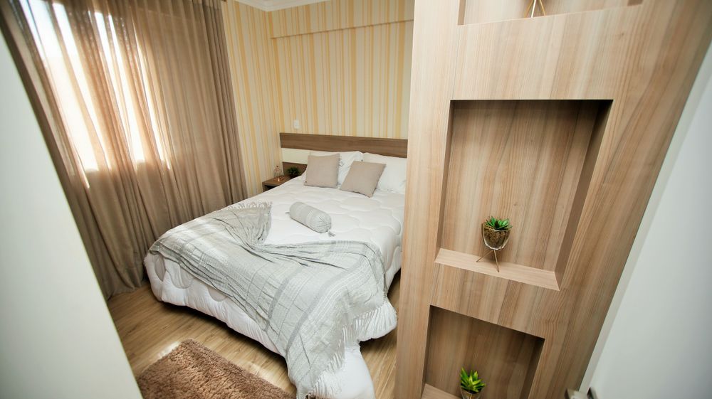 Cozy small bedroom in neutral tones with soft ambient lighting